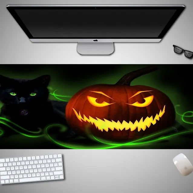 Oversized Halloween themed gaming mouse pad with non-slip rubber cloth base on a desk