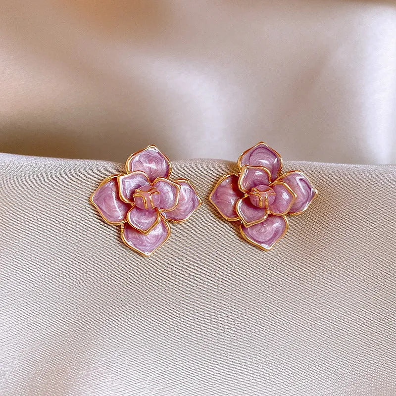 Gold-plated purple oil-spot glaze floral stud earrings on a copper base.