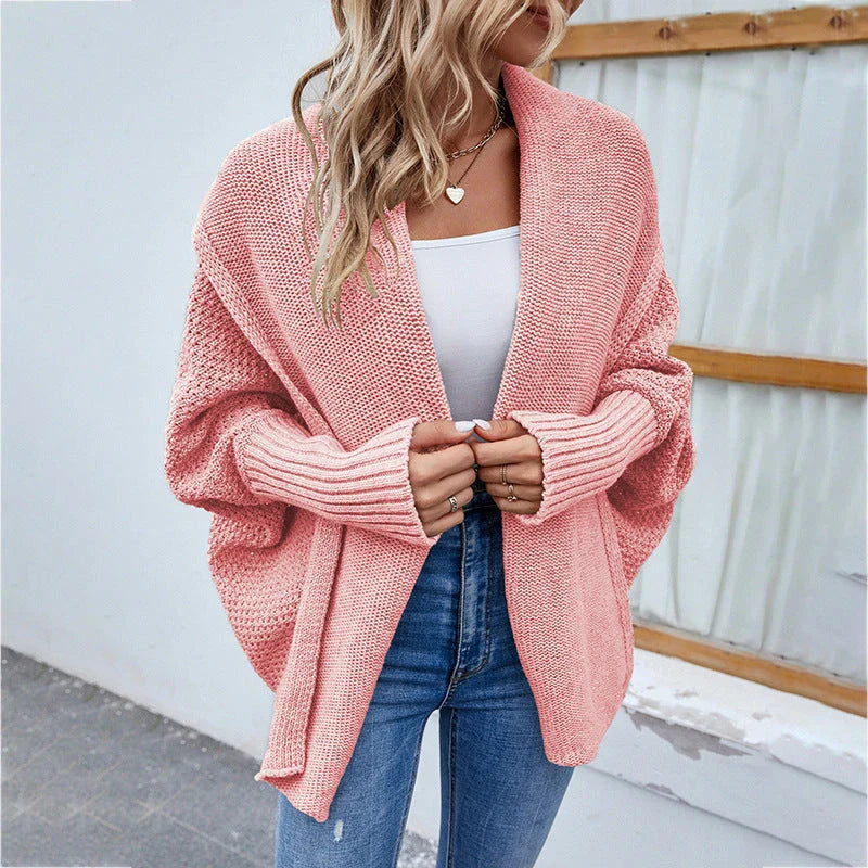 A cozy, oversized knit cardigan with a unique bat-wing sleeve design and large lapel, available in a variety of stylish colors.