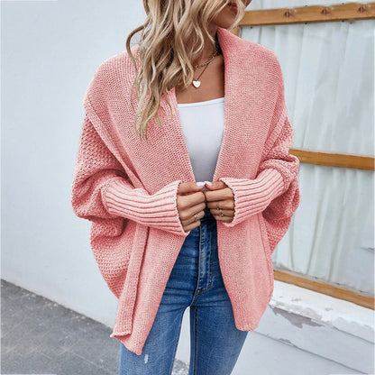 A cozy, oversized knit cardigan with a unique bat-wing sleeve design and large lapel, available in a variety of stylish colors.