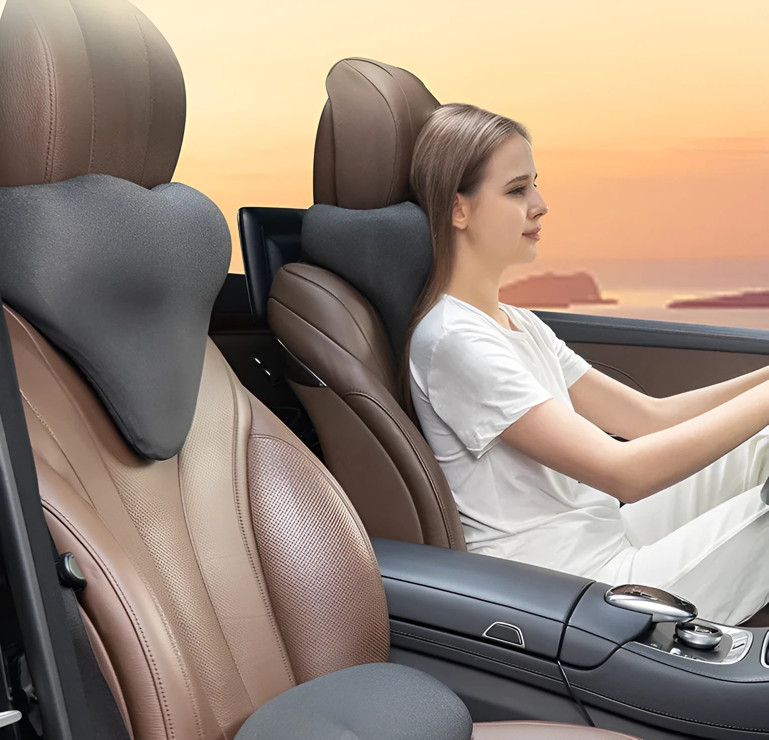 Dark gray memory foam car neck pillow on a car headrest.