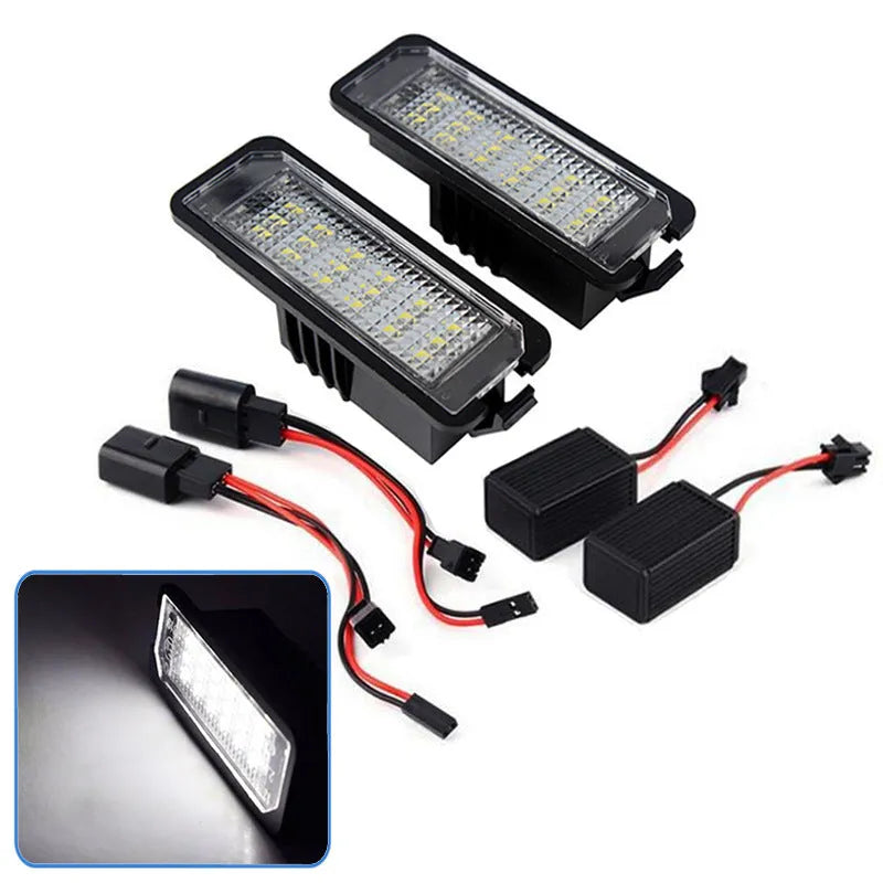 Two Volkswagen LED license plate light bulbs with white LEDs and electrical connectors.