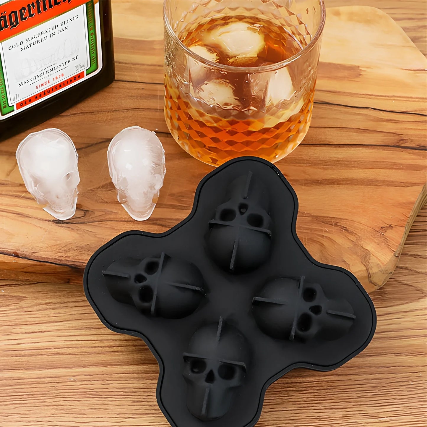 Black silicone ice cube tray with four skull-shaped cavities measuring 12cm long