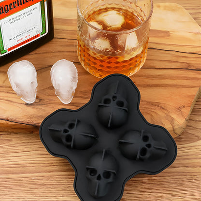Black silicone ice cube tray with four skull-shaped cavities measuring 12cm long