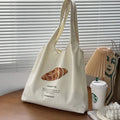 Beige canvas shoulder bag with bread design showing front width and shoulder strap