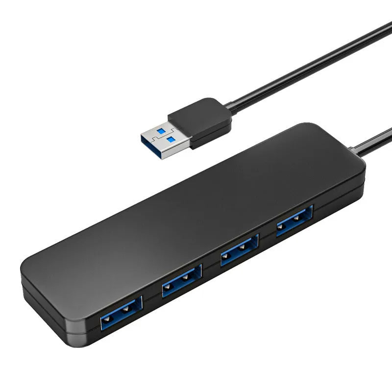 Black USB 3.0 hub with four ports, indicator lights, and a 30cm connecting cable on a desk.