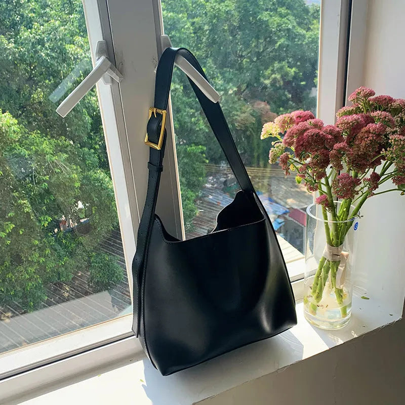 Women's solid colour PU leather shoulder bag in black, square vertical shape with sewing thread detail and single strap