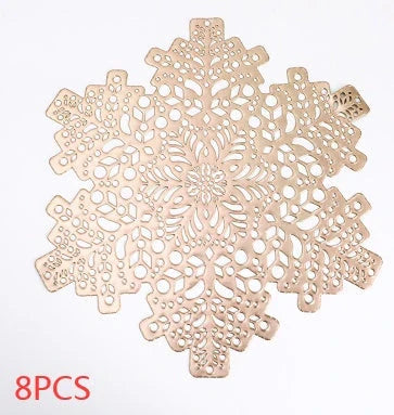 Stylish snowflake-patterned placemats in gold and silver, designed for heat resistance and spill protection on dining tables