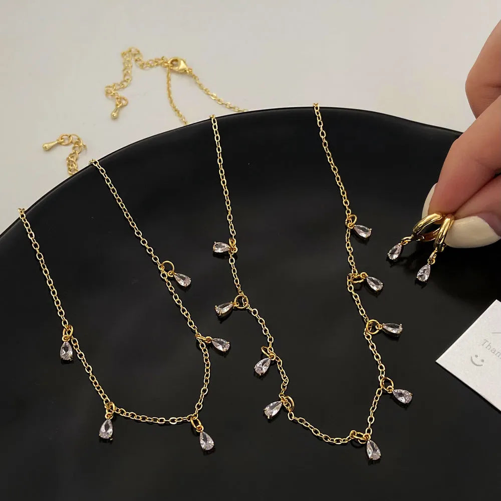 Women's zircon necklace, earrings, and anklet set with geometric meteor shower design.