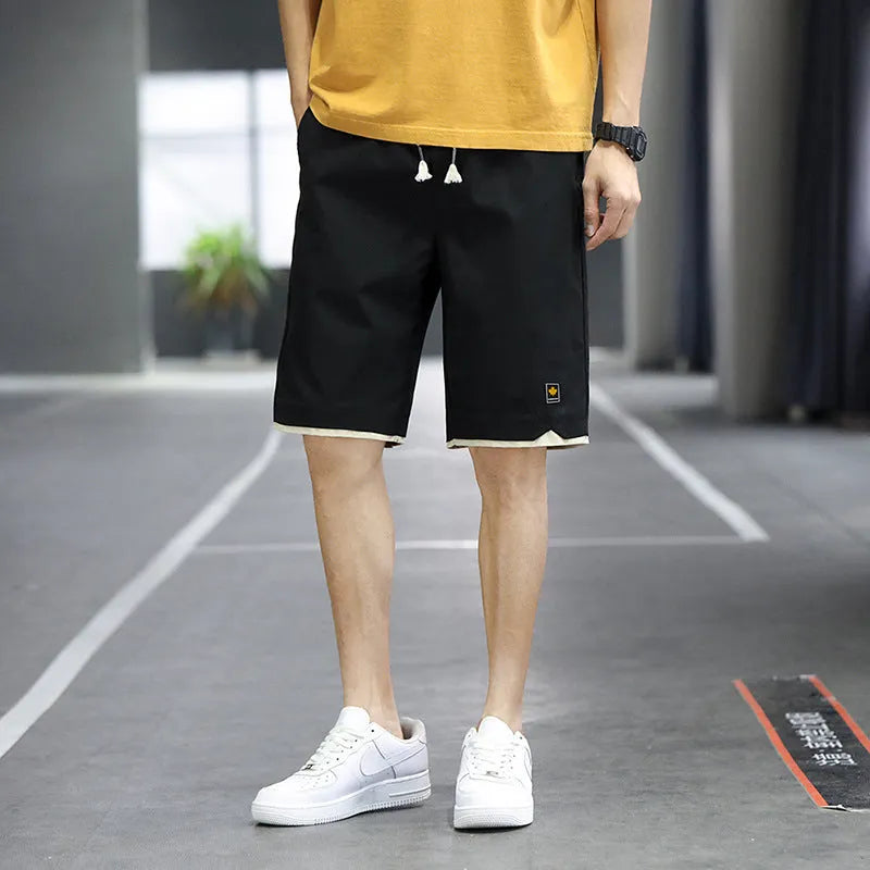 Casual straight-leg loose shorts in green polyester fabric on a neutral background.