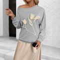 Women's gray 3D flower long sleeve off-shoulder top on model, sweater design, Asian sizing S to XL