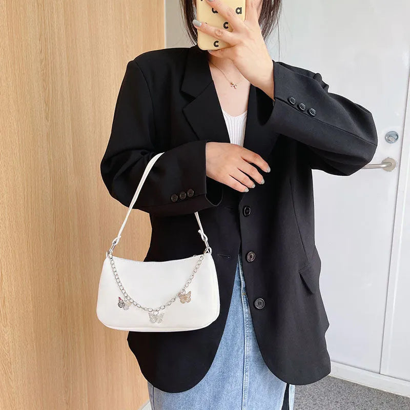 Women's black PU leather crossbody bag with butterfly chain strap and mobile phone pocket