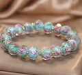 Colour changing artificial crystal bracelet with rose heart design in lake blue finish against a light background