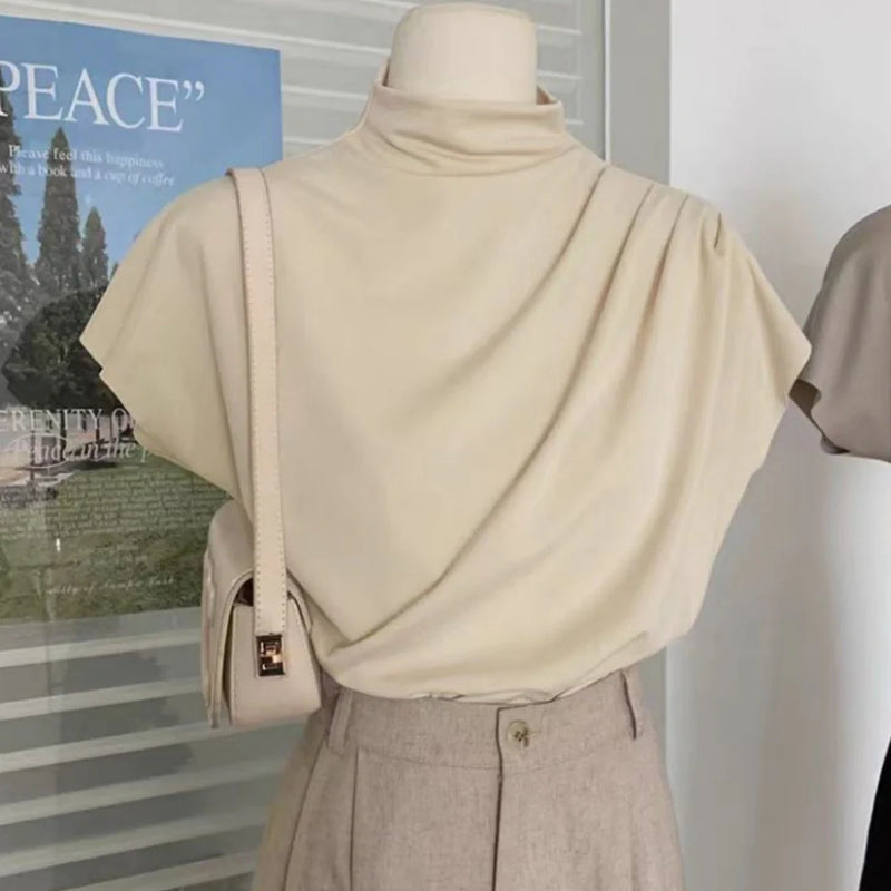 Women's stand-up collar shirt top with oblique pleat design provides a loose fit for unrestricted movement, featuring flying sleeves and available in apricot, black, and khaki colours to suit various preferences.