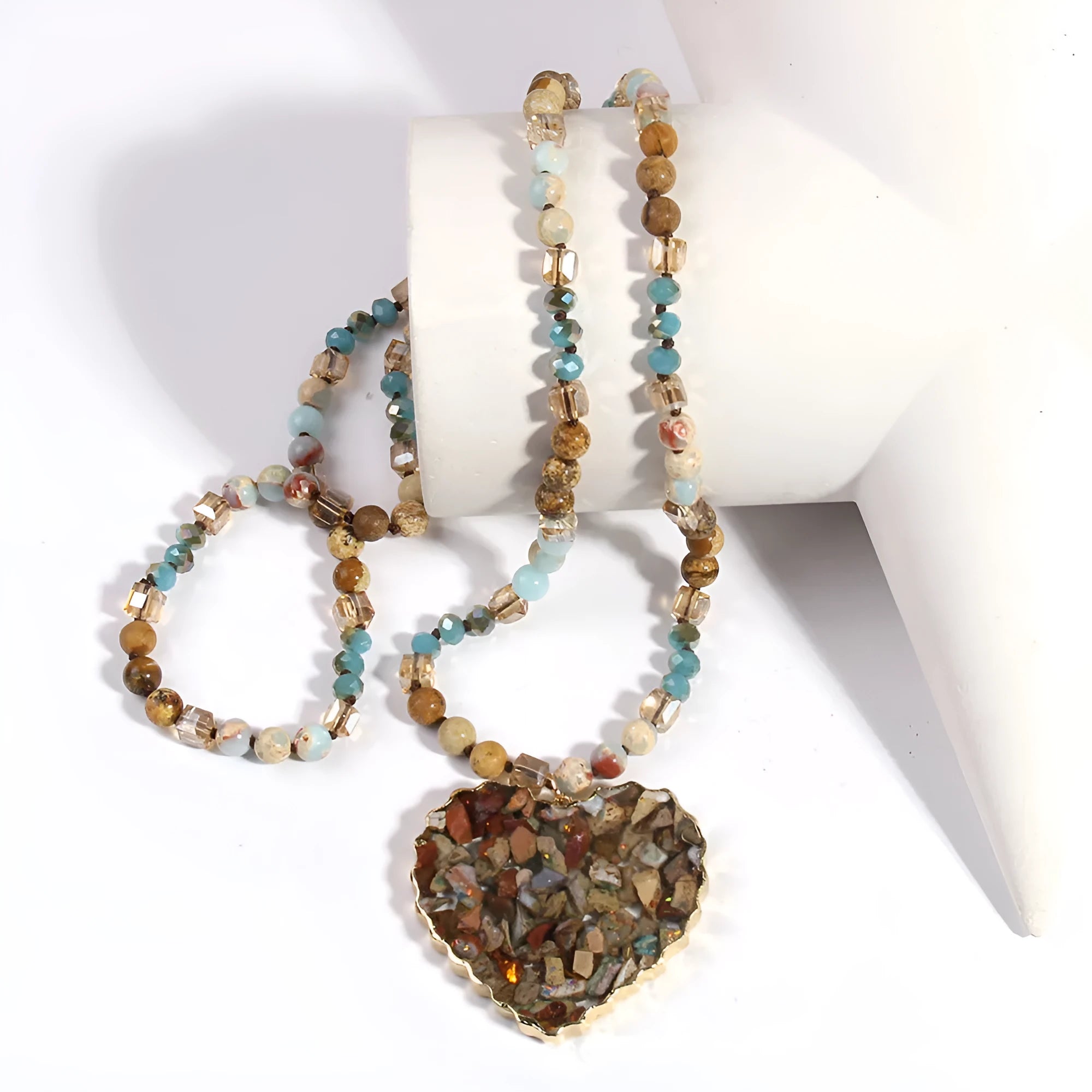 Bohemian style long chain heart pendant necklace in stone and glass with electroplated finish, available in multiple colours.