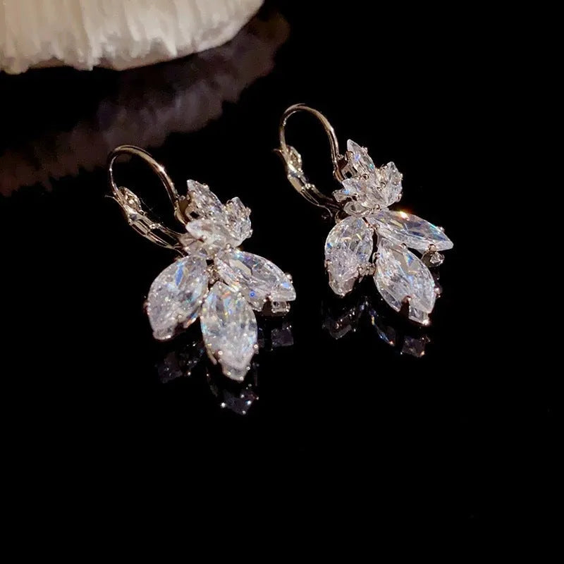 Women's platinum-colour leaf earrings with inlaid shiny zircon stones.