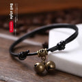 Adjustable nylon dog collar with brass buckle and optional brass bell in black, red, or coffee rope.