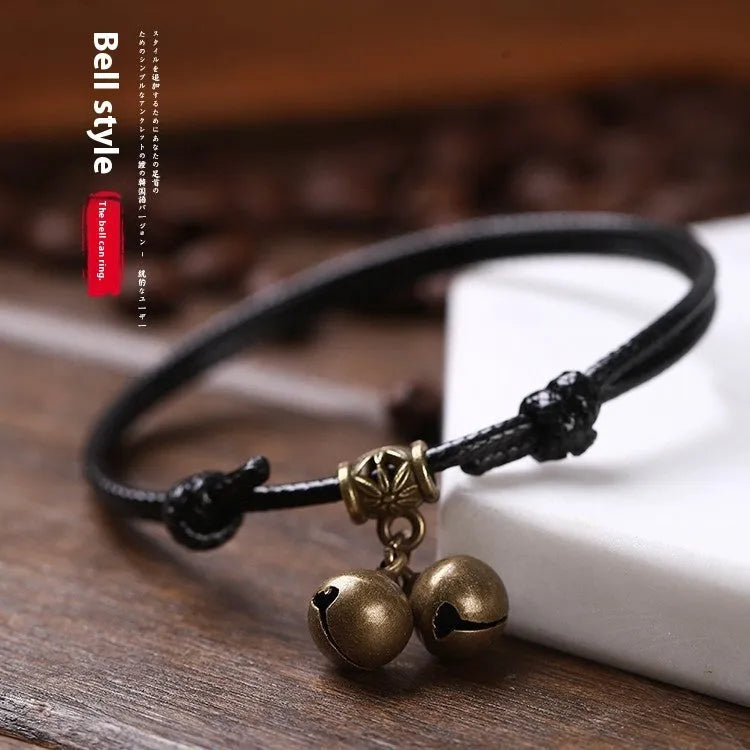 Adjustable nylon dog collar with brass buckle and optional brass bell in black, red, or coffee rope.