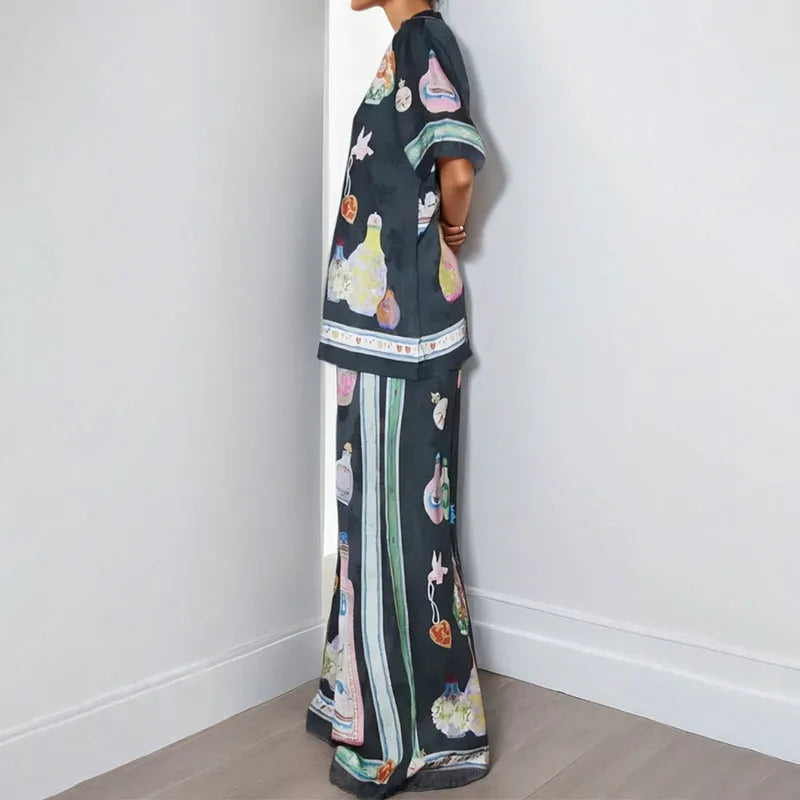 Black women's casual set with cartoon print, featuring a top with regular sleeves and matching trousers.