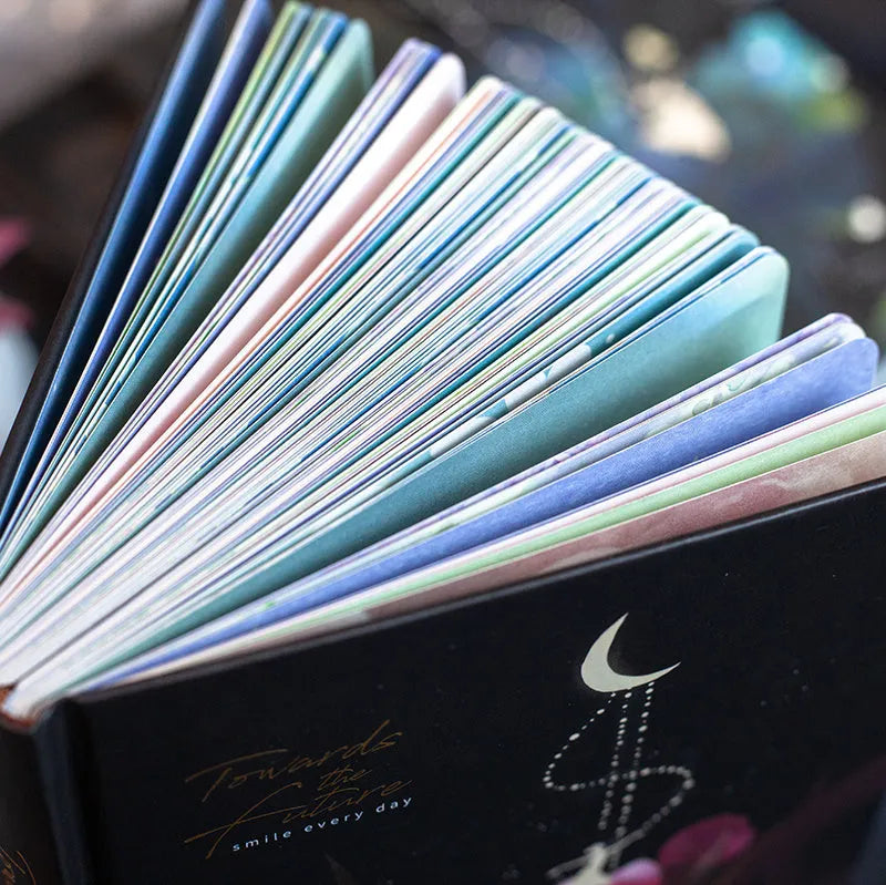 A5 notebook with luminous cover open to show colour illustration inside, in deep blue colour option.