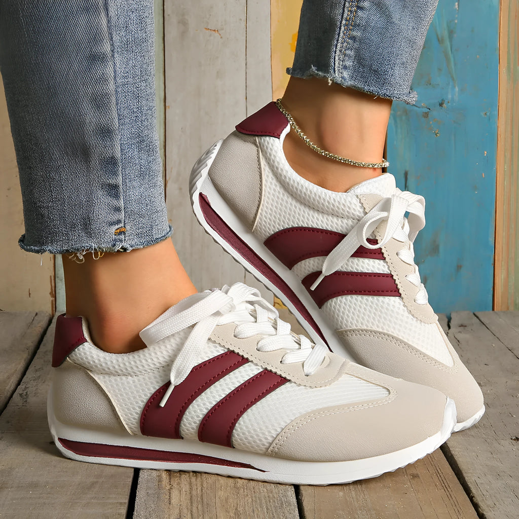 Wine red Cortez-style casual sneakers with a cross-strap detail and mesh lining.