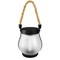 Flickering flame garden lamp with translucent shade in outdoor garden setting