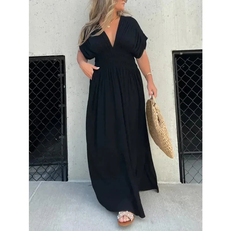 Stylish summer dress featuring unique bat sleeves, v-neck, slit design, and elastic waist for a flattering fit