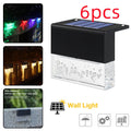 IP65 waterproof solar step light with crystal-like amber cover and RGB LED on a garden path