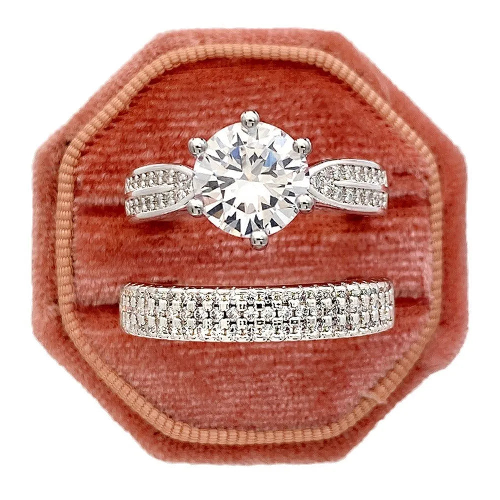 Geometric white gold colour alloy wedding ring on a finger, showing its round design.