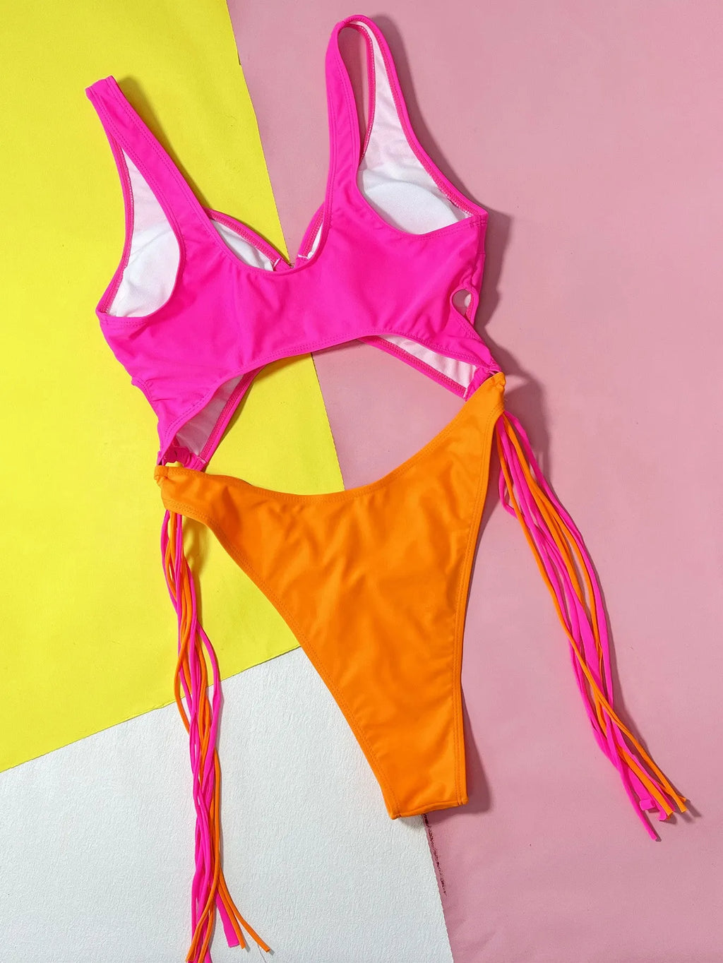 Women's rose red hollow-out steel ring tassel one-piece swimsuit on display