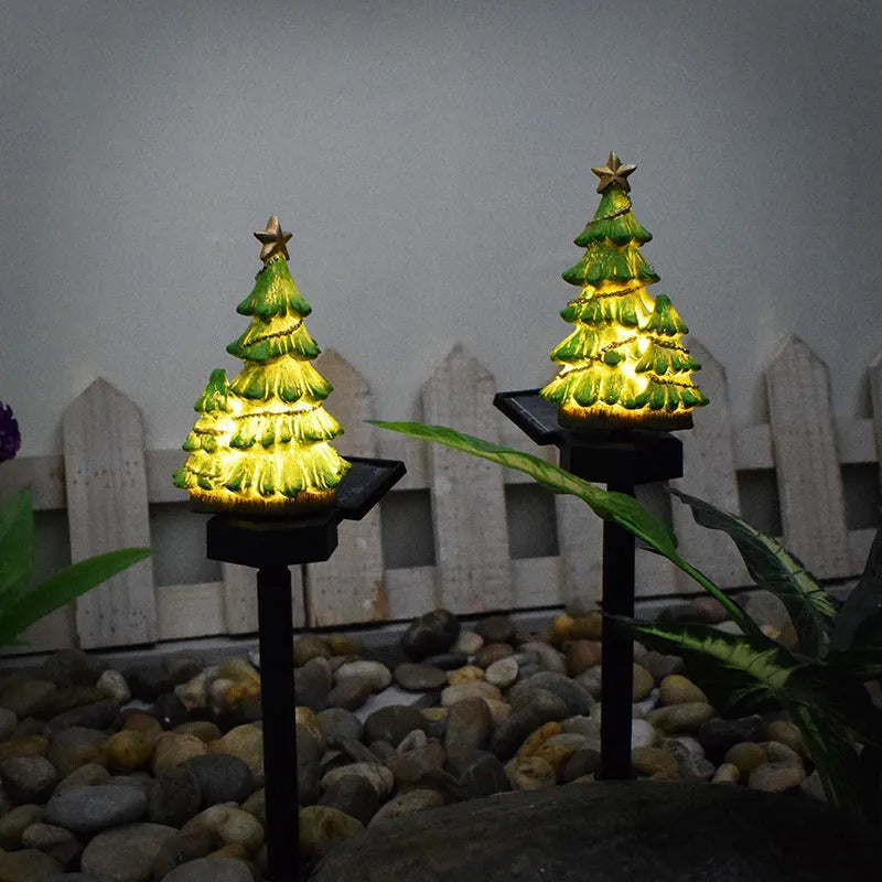 Solar Christmas tree ground plug light with warm white LED on a lawn, IP65 waterproof resin construction