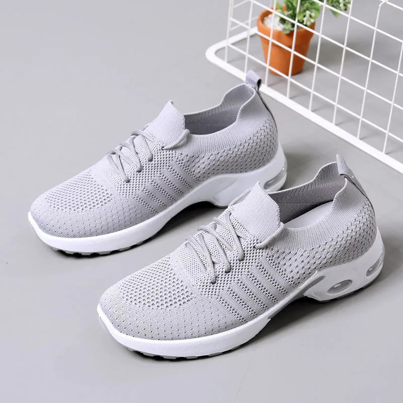 Women's casual mesh sneakers in black with round toe and lace-up front, showing PVC sole