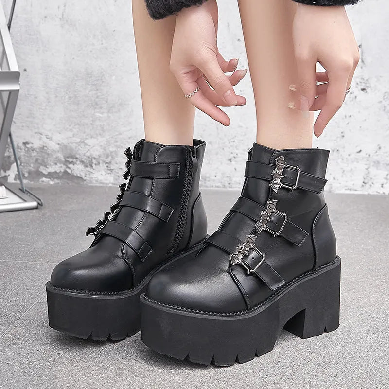 Black women's Harajuku-style punk ankle boots with bat buckle and chunky platform heel.