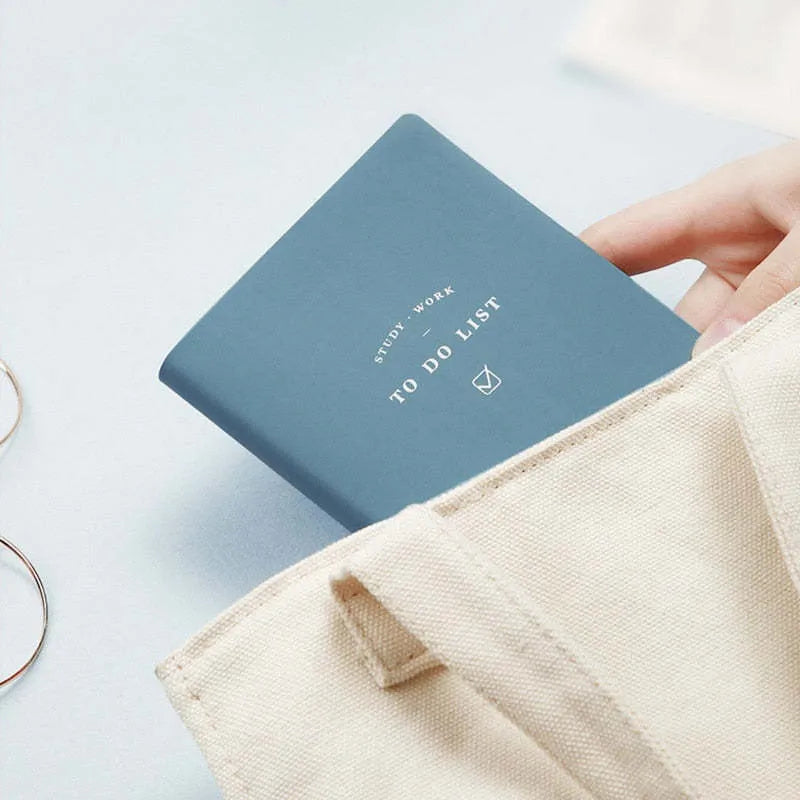 Simple Style 48K PU cover todolist notebook open on a desk, showing Macaron Yellow colour and lined writing paper.