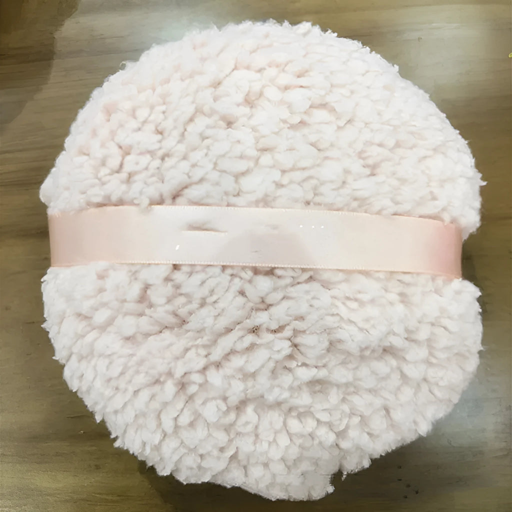 Oversized rectangular plush powder puff for dry makeup application on a white background.