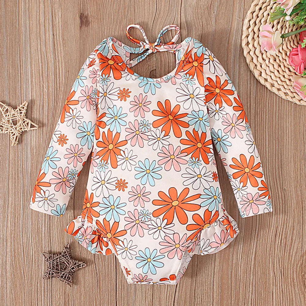 Girl's floral print swimsuit with crew neckline and open back design in orange colour