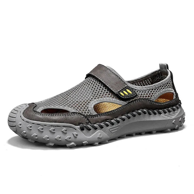 Men's black casual sandals with a mesh upper and velcro strap on a rubber sole.