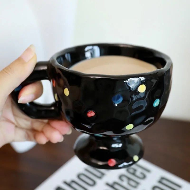 Hand-pinched irregular ceramic mug in a solid colour on a plain background.