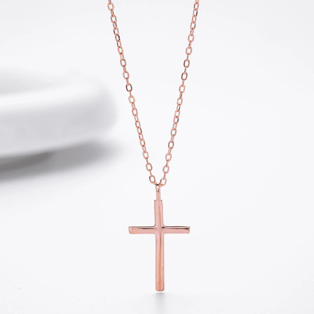Simple glossy cross pendant on an O-shaped sterling silver chain necklace.