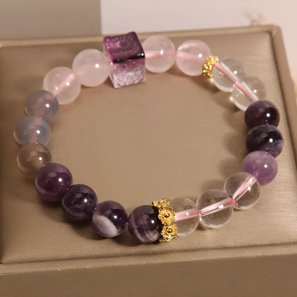 Close-up of a purple women's bracelet with 10mm amethyst crystal beads and rhinestone decoration on an adjustable strap.