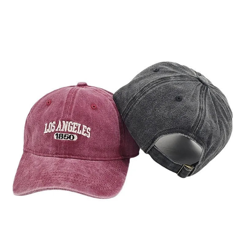 Personalised retro-style peaked cap with embroidered letters on distressed fabric in beige colour.