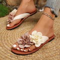 Beige women's flip flop sandals with adjustable strap and two-way flower design on PU upper