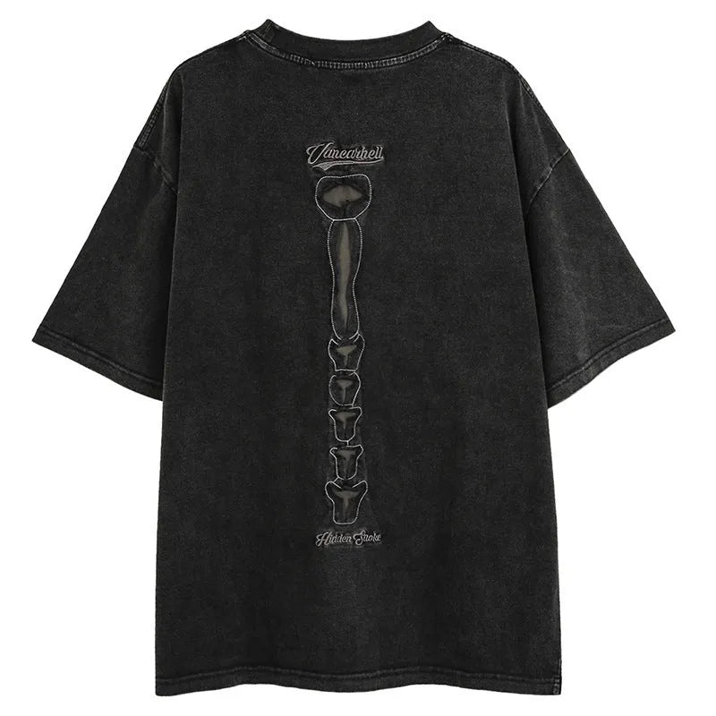 Man wearing a brown loose-fit cotton t-shirt with a large graphic skull print on the front.