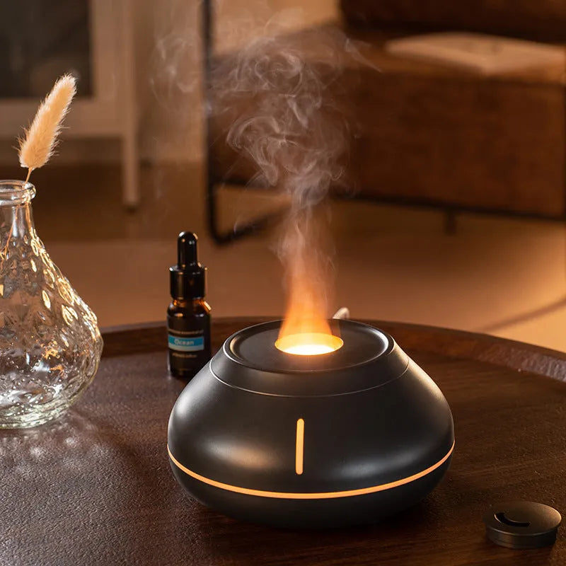 Round resin aroma diffuser with colourful flame effect lighting on desktop