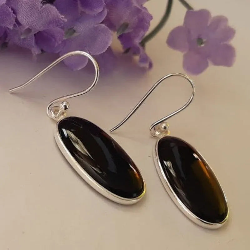 Women's geometric earrings with black agate oval pendants and silver electroplated finish