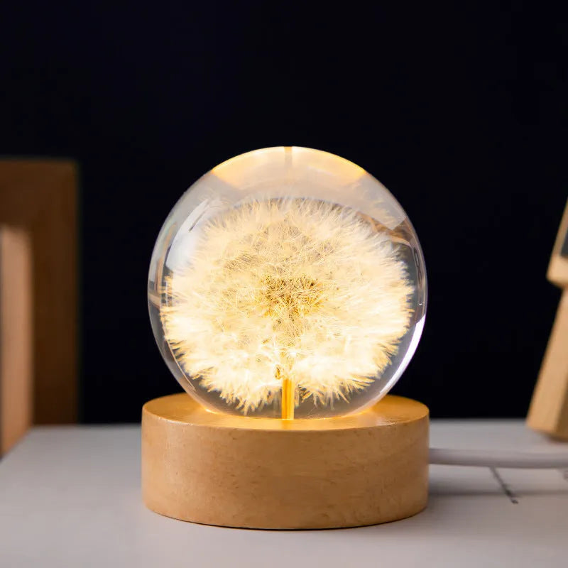 3D dandelion crystal ball desk lamp on beech wood stand, serving as a USB night light.