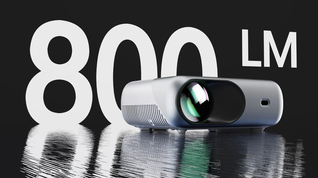 White portable WiFi HD 1080p projector with focus ring and remote control on a table
