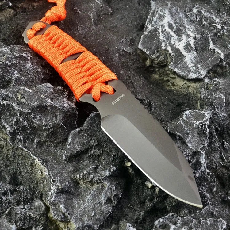 Straight survival knife with rope handle and black ABS sheath on a paper box.