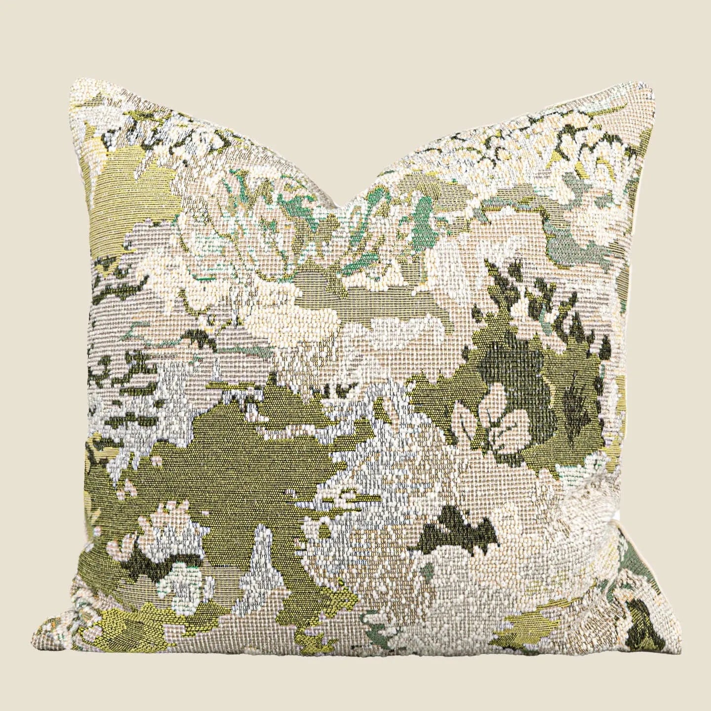 Green antique French style floral pattern wool blend decorative pillow on a sofa.