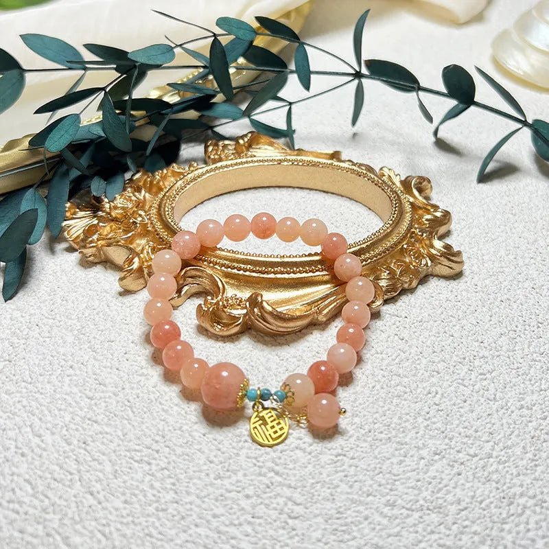 Women's pink natural stone bracelet with alloy metal setting and adjustable clasp
